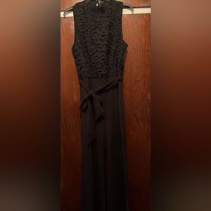 Beautiful woman’s black one piece suit with wrap around tie belt. Size 10